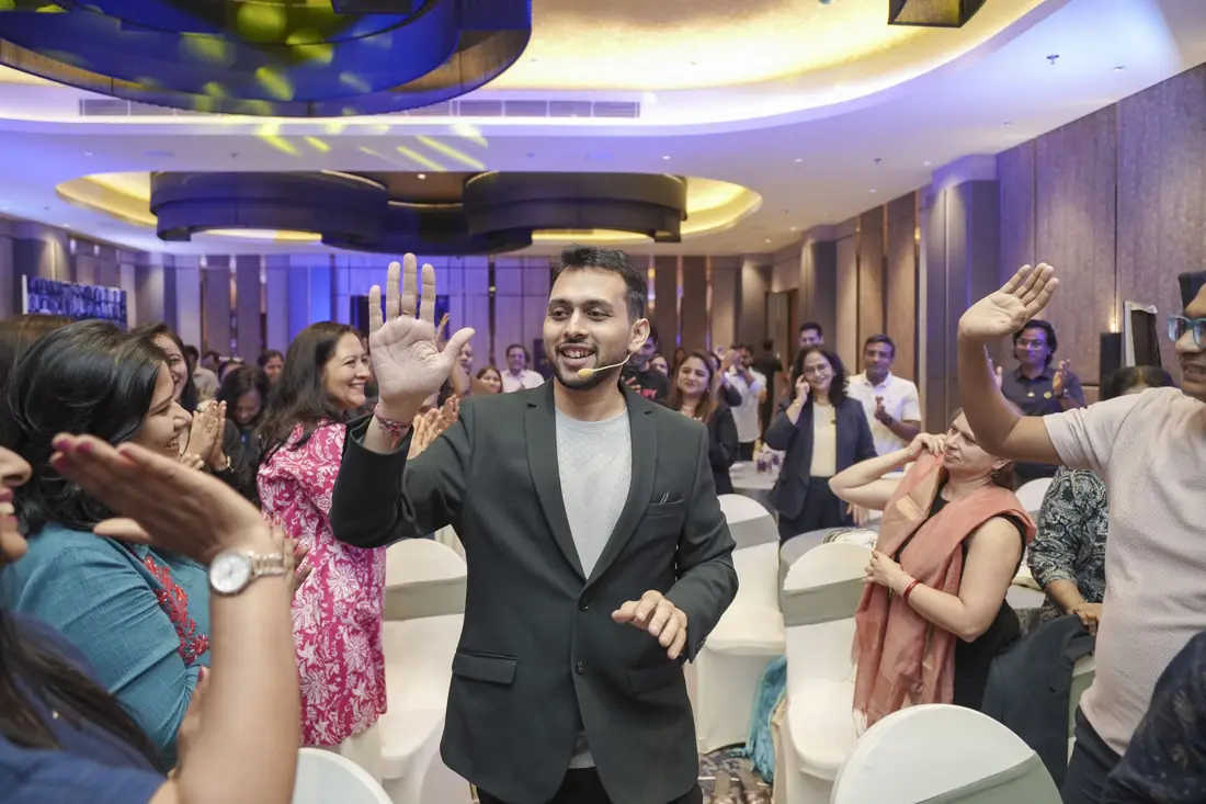 Sagar Sangam Sahu celebrating with coaches from his community at a live event