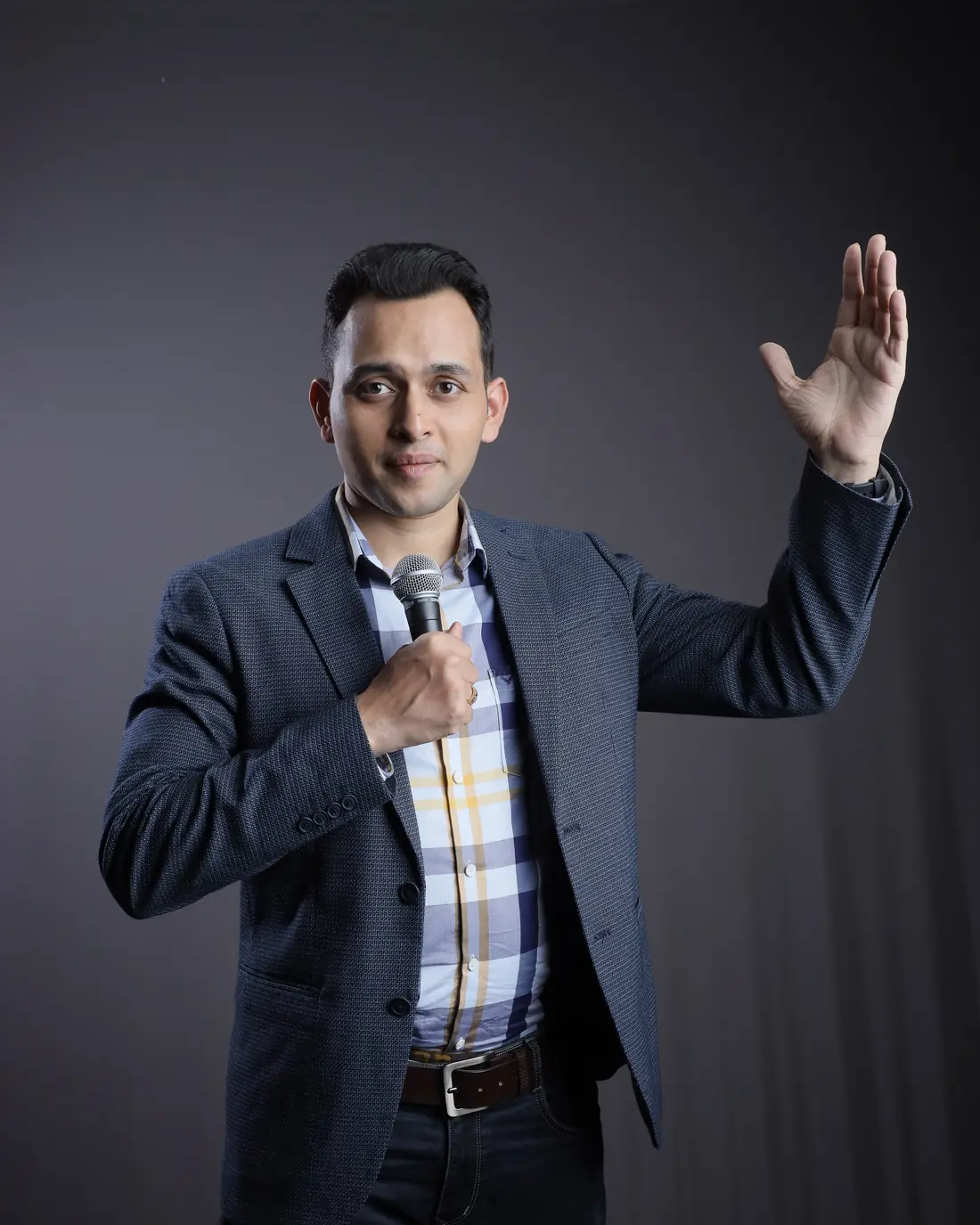 Sagar Sangam Sahu speaking with a microphone, one hand raised